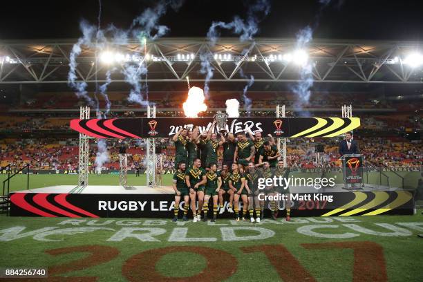 The Kangaroos celebrate with the trophy after winning the 2017 Rugby League World Cup Final between the Australian Kangaroos and England at Suncorp...