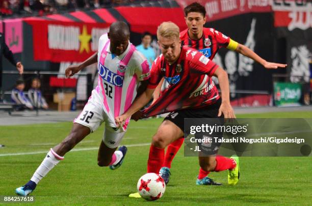 Akito Fukumori of Consadole Sapporo and Victor Ibarbo of Sagan Tosu compete for the ball during the J.League J1 match between Consadole Sapporo and...