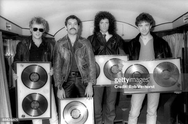 Photo of QUEEN; Collecting gold discs for Greatest Hits - L to R: Roger Taylor, Freddie Mercury, Brian May, John Deacon
