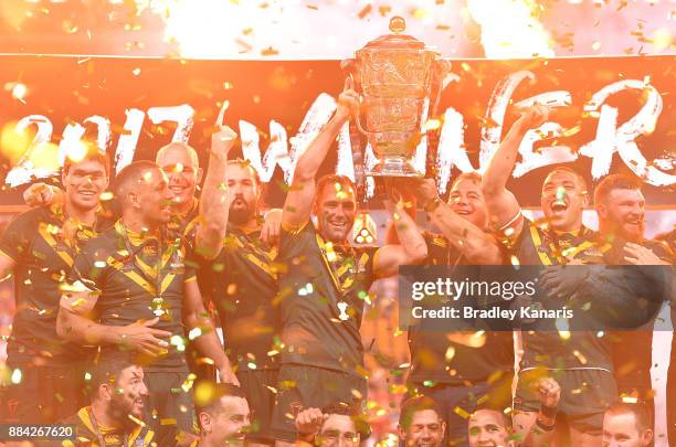 The Australian Kangaroos celebrate victory as captain Cameron Smith holds up the world cup trophy after the 2017 Rugby League World Cup Final between...