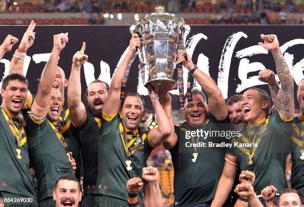 The Australian Kangaroos celebrate victory as captain Cameron Smith holds up the world cup trophy after the 2017 Rugby League World Cup Final between...