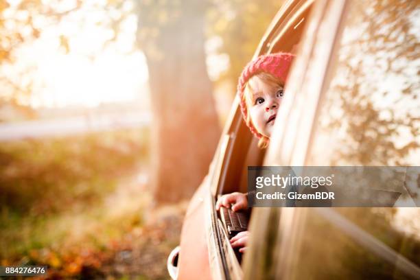 the little boy is looking from the car window - looking out car window stock pictures, royalty-free photos & images