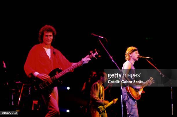 Photo of Mark KNOPFLER and John ILLSLEY and DIRE STRAITS and Mark KNOPFLER; L-R: John Illsley, Jack Sonni , Mark Knopfler performing live onstage