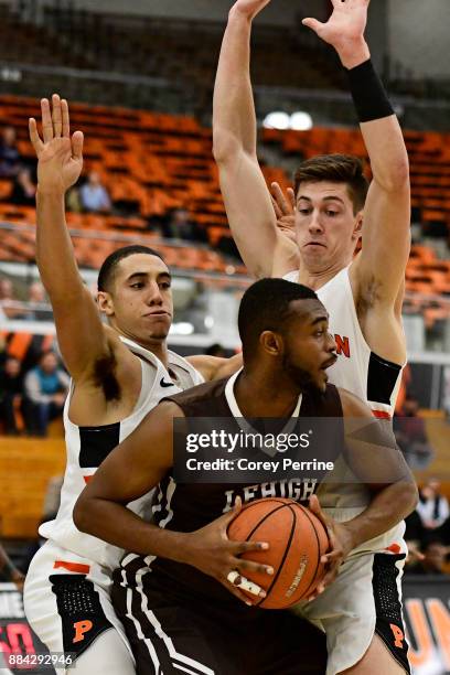 Ed Porter of the Lehigh Mountain Hawks is double teamed by Devin Cannady and Mike LeBlanc of the Princeton Tigers during the second half at L....