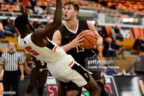 James Karnik of the Lehigh Mountain Hawks looks to score as Amir Bell of the Princeton Tigers flops during the second half at L. Stockwell Jadwin...