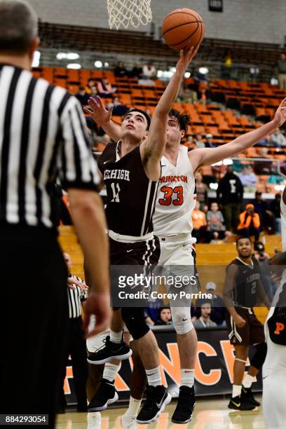 Jordan Cohen of the Lehigh Mountain Hawks scores against Sebastian Much of the Princeton Tigers during the second half at L. Stockwell Jadwin...