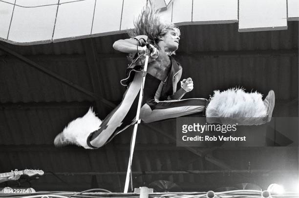 Photo of David Lee ROTH and VAN HALEN; David Lee Roth jumps through the air while performing live on stage at the Pinkpop Festival in Geleen