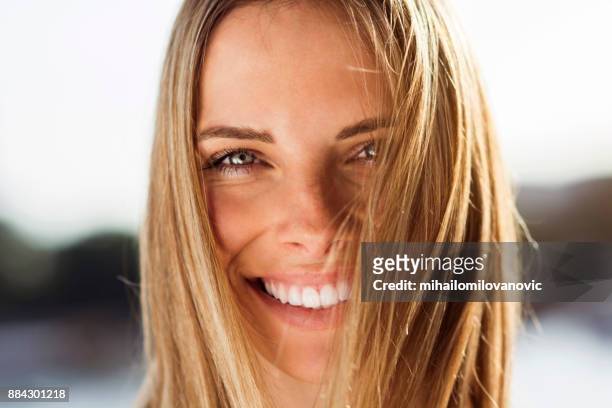 happy woman posing - tossing hair facing camera woman outdoors stock pictures, royalty-free photos & images