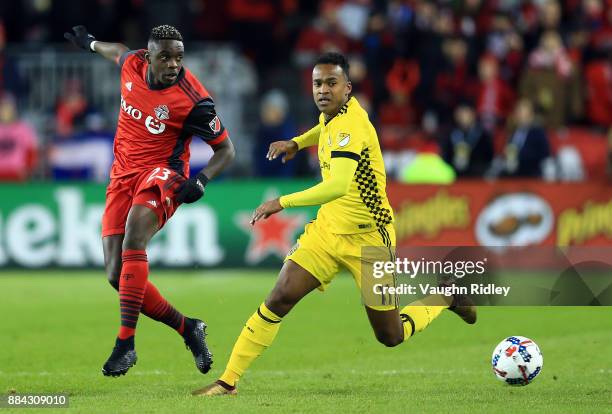 Chris Mavinga of Toronto FC and Ola Kamara of Columbus Crew SC chase a loose ball during the first half of the MLS Eastern Conference Finals, Leg 2...