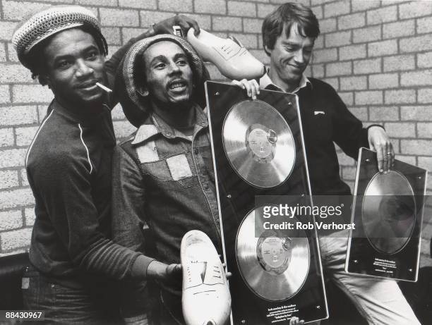 Photo of Bob MARLEY, posed in dressing room with Anton Witkamp of Warner Music receiving award for Babylon By Bus