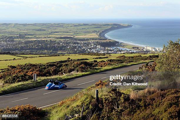 The town of Ramsey catches the evening light in the distance as a competitor rides during a practice session on June 5 Isle Of Man, United Kingdom....