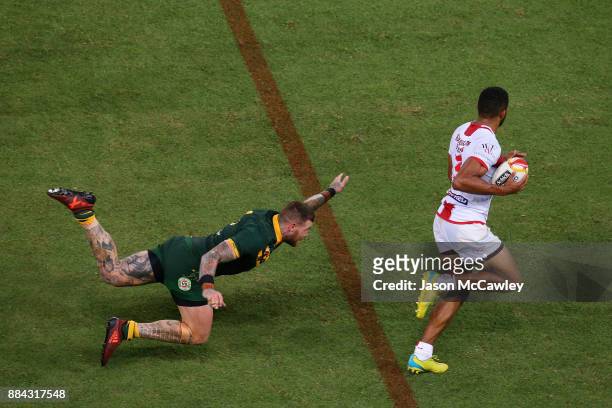 Kallum Watkins of England evades the tackle of Josh Dugan of Australia during the 2017 Rugby League World Cup Final between the Australian Kangaroos...
