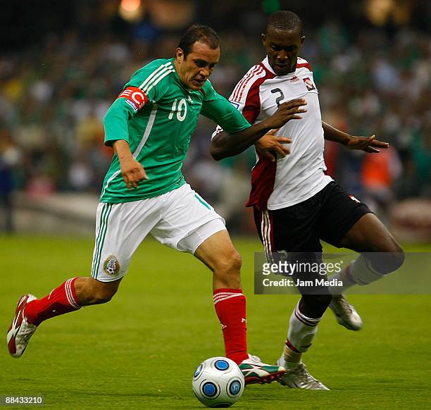 Mexico's Cuauhtemoc Blanco vies for the ball with Trindad & Tobago's Hislop Makan during their 2010 FIFA World Cup qualifier at the Azteca Stadium on...