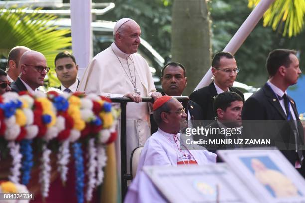 Pope Francis arrivs for a meeting with young people at Notre Dame College in Dhaka on December 2, 2017. Pope Francis arrived in Bangladesh from...