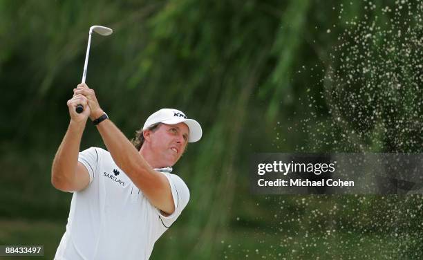 Phil Mickelson of the United States hits a bunker shot on the 12th hole during the first round of the St. Jude Classic at TPC Southwind held on June...