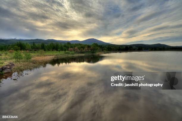 cloudscape reflecting in lake  - hachimantai stock pictures, royalty-free photos & images