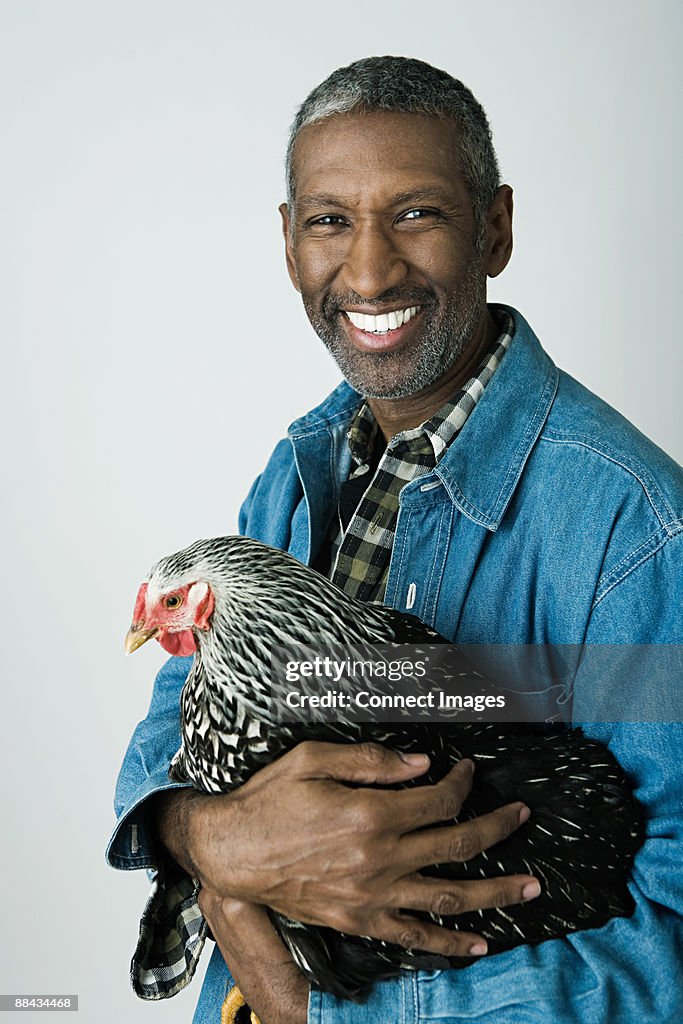 Man holding a chicken