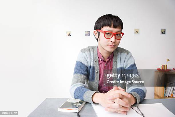 young man wearing glasses - geek stock-fotos und bilder