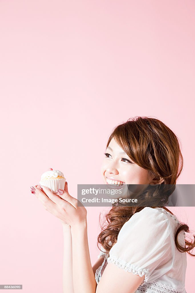Woman holding cup cake