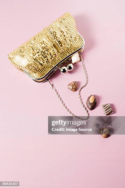 chocolates in a handbag - gold purse stock pictures, royalty-free photos & images