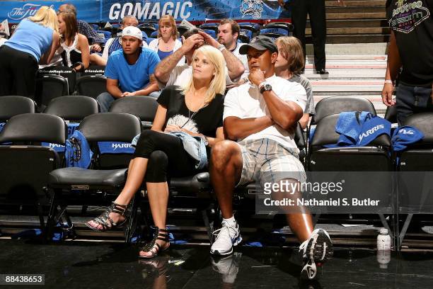 Golfer Tiger Woods sits courtside with his wife Elin as they get set to watch the Los Angeles Lakers play against the Orlando Magic in Game Four of...