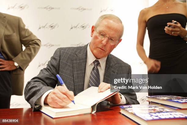 New York Giants Coach Tom Coughlin autographs his book "A Team To Believe In" at the dress to win event hosted by Joseph Abboud and Lord & Taylor at...