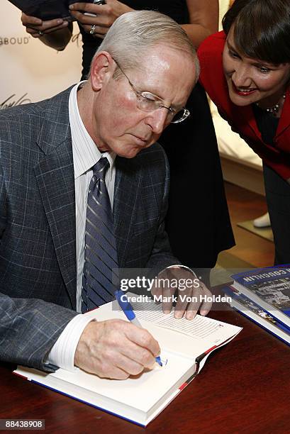 New York Giants Coach Tom Coughlin autographs his book "A Team To Believe In" at the dress to win event hosted by Joseph Abboud and Lord & Taylor at...