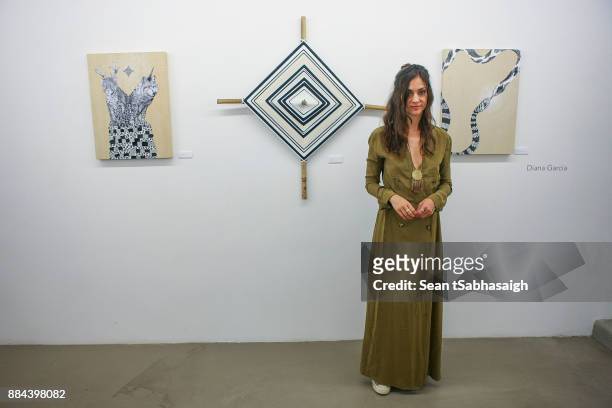 Artist Diana Garcia poses in front of her artwork at OptiMystic: A Brandon Boyd Pop Up Gallery Featuring He, Tasya Van Ree, Natalie Bergman, Diana...