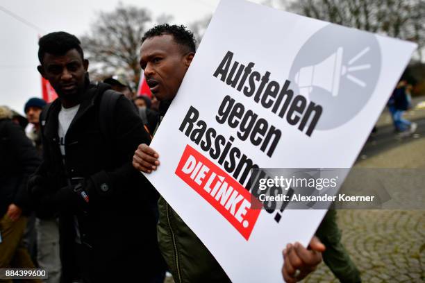 Demonstrator protests against racism while marching in a protest against todays AfD federal congress at the Hannover Congress Centrum on December 2,...
