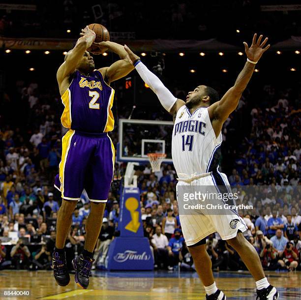 Derek Fisher of the Los Angeles Lakers shoots a game-tying three-point shot over Jameer Nelson of the Orlando Magic in the fourth quarter of Game...