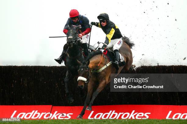 Harry Cobden jumps the last on Elegant Escape ahead of Bryony Frost on Black Cotton to win The Ladbrokes John Francome Novies' Steeple Chase as...