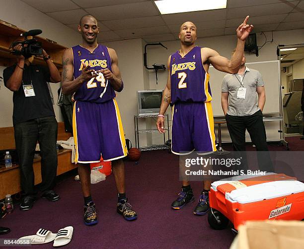 Derek Fisher of the Los Angeles Lakers addresses the team in the locker rom as teammate Kobe Bryant looks on after their 99-91 overtime win against...