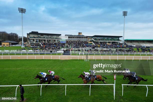 Riders pass the grandstand during the Weatherbys Racing Bank 'The French Furze' Novice Hurdle Race at Newcastle Racecourse on December 2, 2017 in...