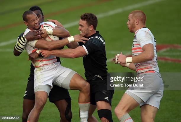 Dan Norton of England is tackled during the Cup Semi Final match between New Zealand and England on Day Three of the Emirates Dubai Rugby Sevens -...