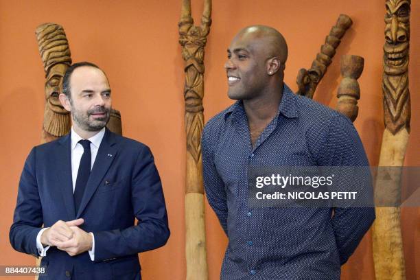 French Prime Minister Edouard Philippe stands next to French judoka Teddy Riner during a meeting with 'ambassadors for the registration on the...