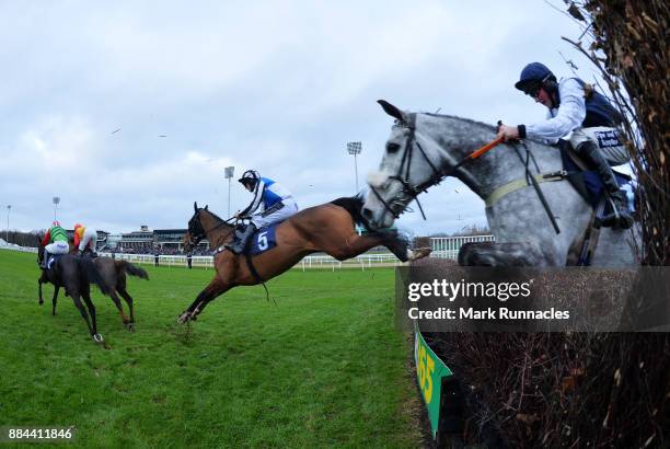 Riders clear the final fence during the Weatherbys General Book Online Steeple Chase at Newcastle Racecourse on December 2, 2017 in Newcastle upon...