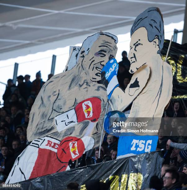 Fans of Hoffenheim show figures of Dietmar Hopp and Dietrich Mateschitz in a boxing fight during the Bundesliga match between TSG 1899 Hoffenheim and...