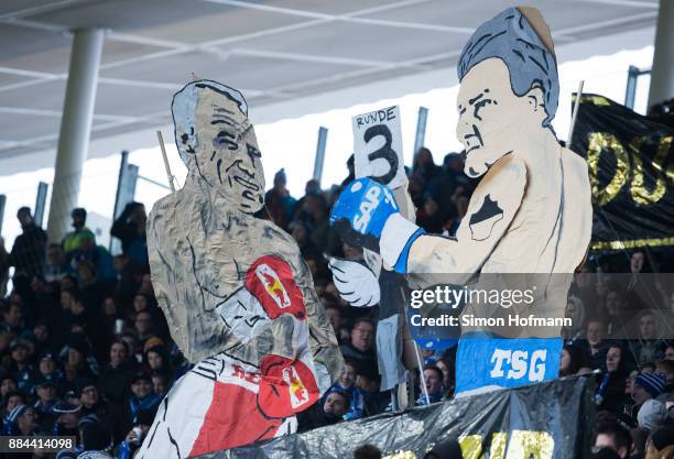 Fans of Hoffenheim show figures of Dietmar Hopp and Dietrich Mateschitz in a boxing fight during the Bundesliga match between TSG 1899 Hoffenheim and...