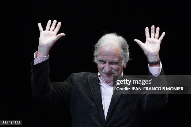 Member of the Europe Ecologie - Les Verts green party Noel Mamere waves after delivering a speech during the founding congress of the left-wing...