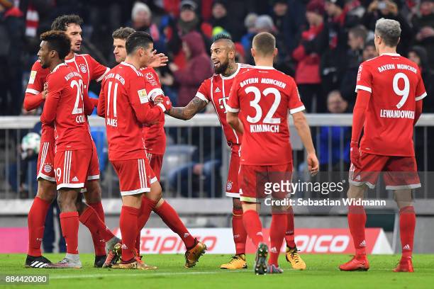 Arturo Vidal of Bayern Muenchen celebrates with James Rodriguez of Bayern Muenchen after he scored a goal to make it 1:0 during the Bundesliga match...