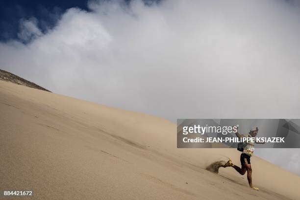 Competitor takes part in the fourth stage of the first edition of the Marathon des Sables Peru between Ocucaje and Barlovento on December 1 in the...