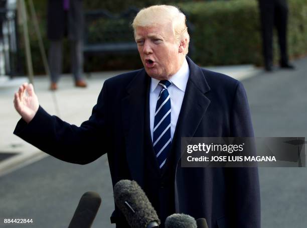 President Donald Trump speaks with the media before boarding Marine One during his departure at the White House in Washington, DC, on December 2 en...