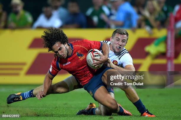 Jacobo Martin of Spain is tackled by Thibauld Mazzoleni of France during the Trophy Final match between France and Spain on Day Three of the Emirates...