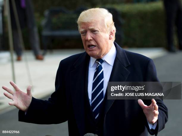 President Donald Trump speaks with the media before boarding Marine One during his departure at the White House in Washington, DC, on December 2 en...