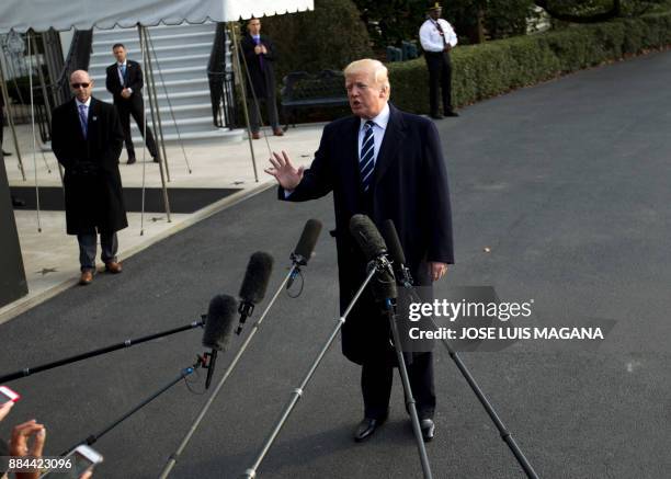 President Donald Trump speaks with the media before boarding Marine One during his departure at the White House in Washington, DC, on December 2 en...