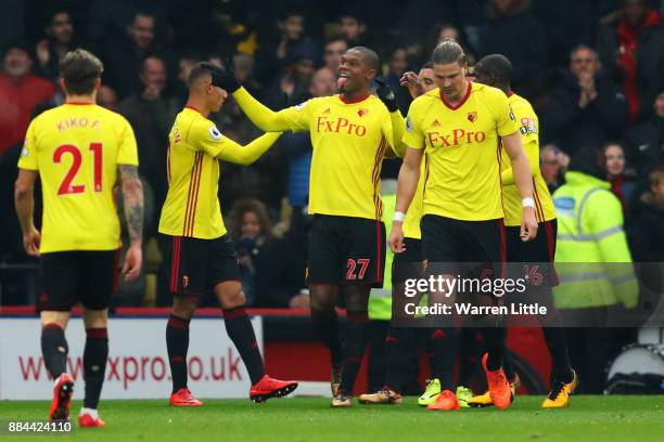 Christian Kabasele of Watford celebrates after scoring his sides first goal with his Watford team mates during the Premier League match between...