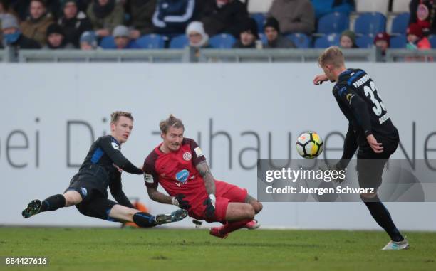 Lukas Boeder of Paderborn controls the ball n ear Manuel Schaeffler of Wiesbaden and Sebastian Schonlau of Paderborn during the 3. Liga match between...