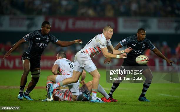 Ruaridh McConnochie of England passes the ball during the Bronze Medal Final match between Fiji and England on Day Three of the Emirates Dubai Rugby...