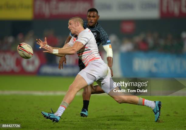 Ruaridh McConnochie of England passes the ball during the Bronze Medal Final match between Fiji and England on Day Three of the Emirates Dubai Rugby...