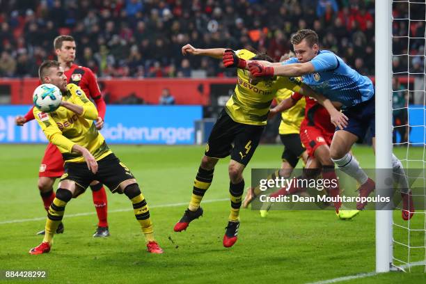 Goalkeeper Bernd Leno of Bayer Leverkusen saves against Neven Subotic of Dortmund during the Bundesliga match between Bayer 04 Leverkusen and...